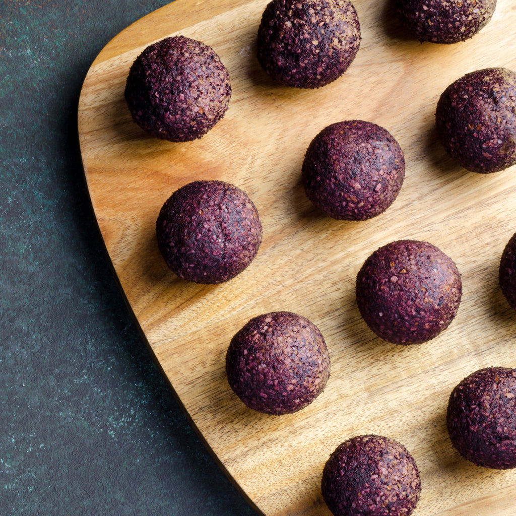 Red energy balls on a wooden board